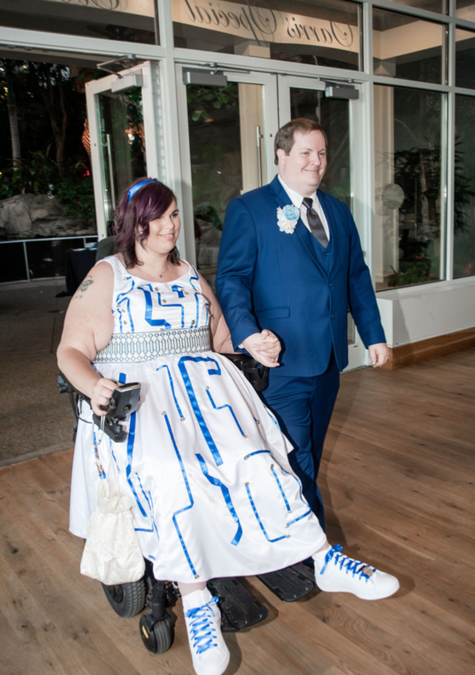 Couple in R2-D2 inspired custom wedding dress with groom in blue suit