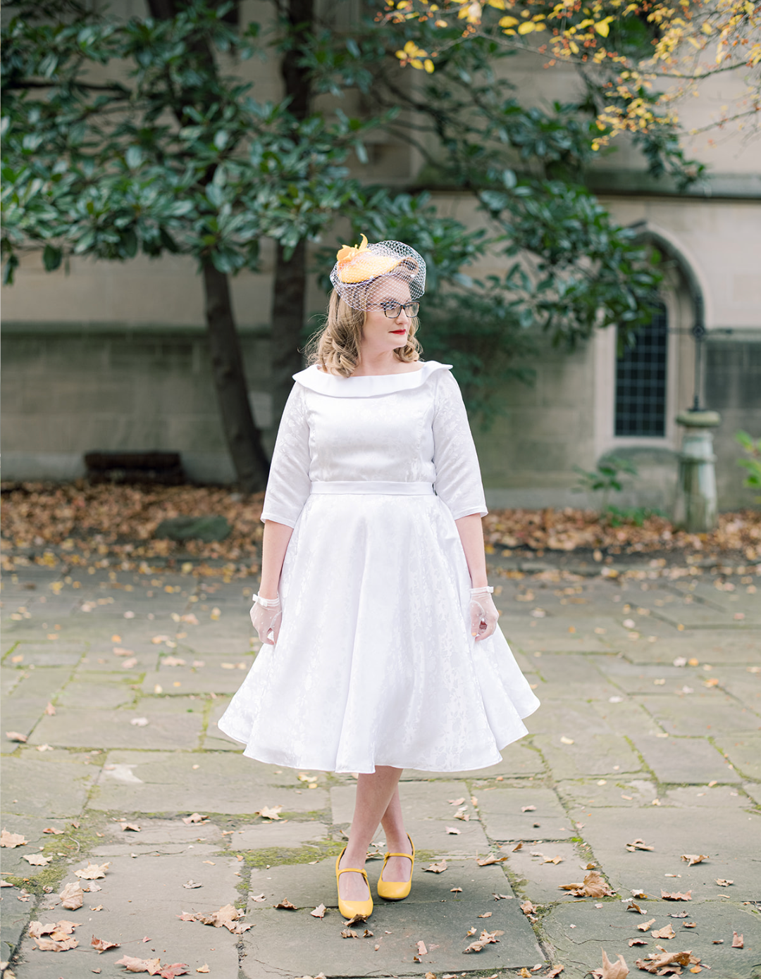 Bride in 1950s style tea-length gown with yellow heels outdoors